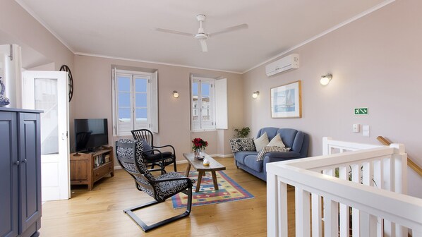 Living room on first floor with air conditioning and ceiling fan