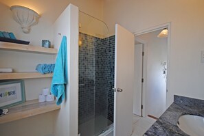 Blue, glass tiles  in master bathroom shower.