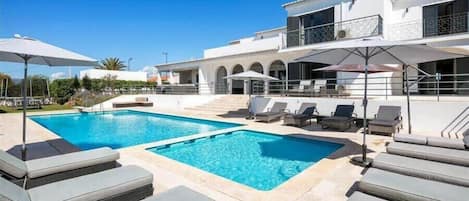 Ample sun loungers by the pool