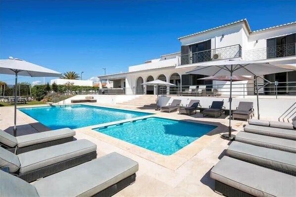 Ample sun loungers by the pool