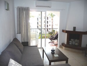 Living room with fireplace and balcony