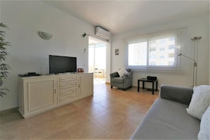 Bright and spacious lounge with air conditioning and international TV