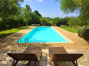 Wooden sun lounges and pool