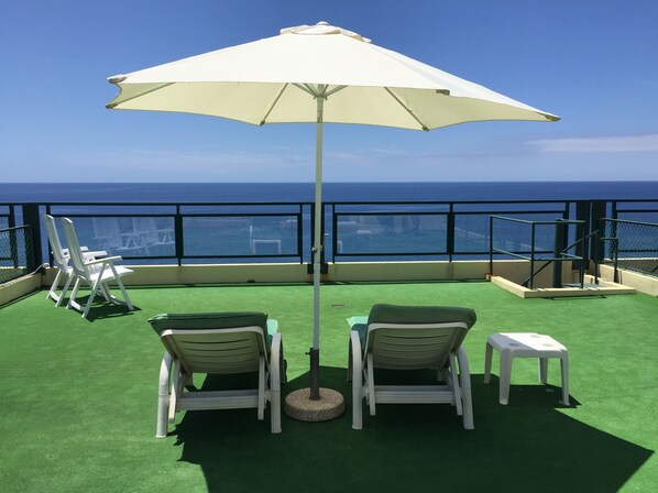 Relaxing at rooftop terrace with ocean view