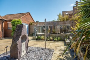 Greyseals, Brancaster: The walled garden with  raised decking area