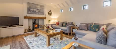 Greyseals, Brancaster: Sitting room with wood burning stove