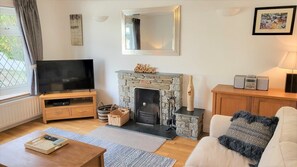 Lounge with 2 comfy sofas, fireplace and large Smart TV