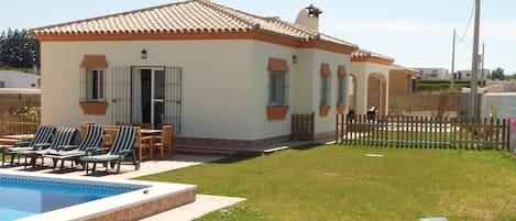 View of the villa, with a picket fence to separate the pool area.