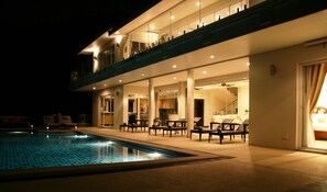 View of Villa at night from pooldeck dining area