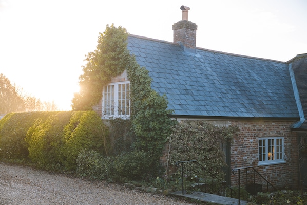 The Brew House forms the east wing of the Grade II listed Knighton Farmhouse