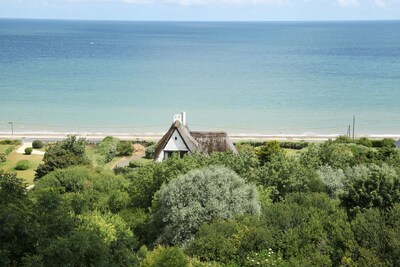 Thatched cottage by the sea at Omaha Beach