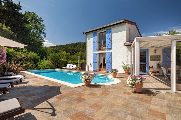 The sunny terrace that wraps around the swimming pool