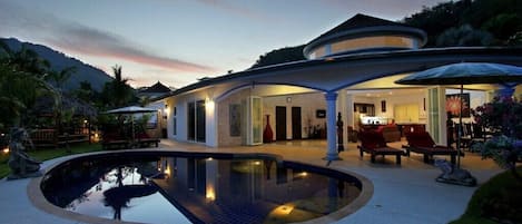 Front view of your villa with private pool at sunset