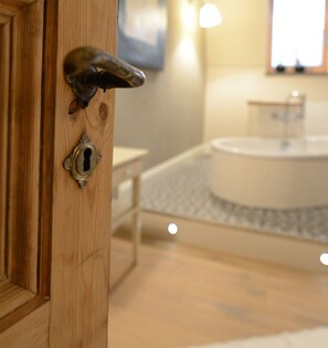 A view inside the bathroom with its ancient doors and beautiful floorings.