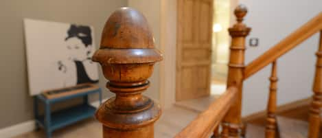 The ancient original staircase graces the hallway of the apartment.