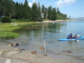 Launching the kayak from the beach in front of the cottage.