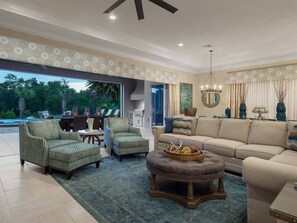 The living area has plenty of comfortable seating and opens to the covered lanai