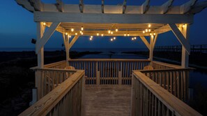 Tidal Wave Pergola with String Lights at Night