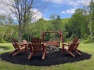 Smores time around the outside firepit with Adirondack chairs and swing. 