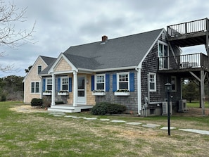 Front of house showing stepping stones and newly-planted grass.