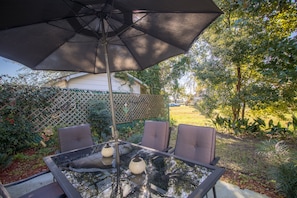 Back patio set is great for dining or relaxing while enjoying waterfront views