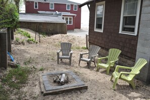 Backyard fire pit and sandy hill for the littles!