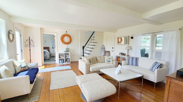 Living room has plenty of seating and a flat screen TV