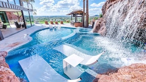 Incredible rock side pool w/ loungers, waterfall, spa, & amazing desert views