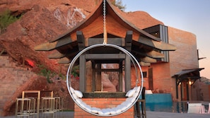 Unique swing chair in backyard w/ views next to the outdoor covered kitchen