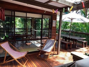 Deck area with outdoor table, chairs and umbrella.