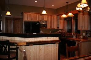 Fully stocked kitchen with custom cabinets/counter tops and gas stove