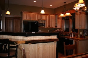 Fully stocked kitchen with custom cabinets/counter tops and gas stove