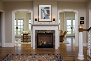 Fireplaced foyer opens to an inviting living space and veranda with water views