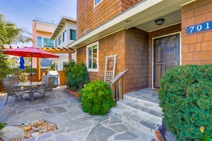 Front entrance with patio with table, umbrella and 4 chairs