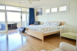 Upstairs master suite with ensuite, king bed, private balcony views and cot.