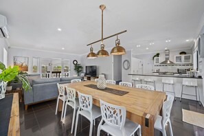 Dinning room with adjoining breakfast bar and exit to undercover alfresco area