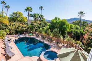Many sun loungers and shaded poolside seating