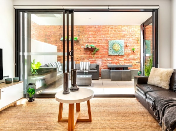 Lounge with double doors opening to courtyard.  Magnificent space to be enjoyed