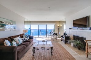 Living room with gas fireplace and TV with Cable. Indoor dining table for 4, and outdoor balcony seating for 2 with electric grill!