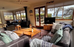 large & comfortable living area with double doors leading to deck