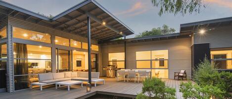 Outdoor deck with dining and sofas