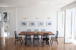 Dining area with vintage Louis Poulsen lamps and paintings by Edo Murtić