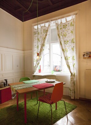 window overlooking green courtyard and table, breakfast amenities