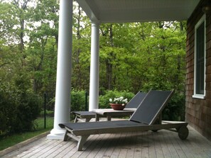 View of covered porch. Hedged and fenced from main house for privacy