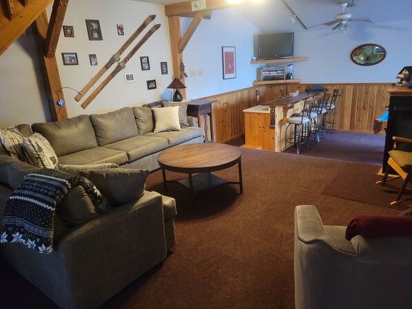 Spacious living room with a large sectional and a 3 sided gas fireplace