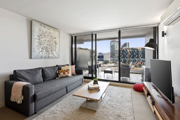 Lounge Area leading to a large balcony overlooking Docklands