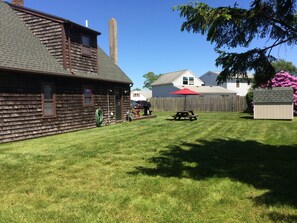 large backyard, additional picnic table with umbrella, outside shower 