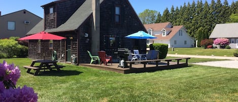 Side deck + entry, 6 seat patio set, picnic table, gas grill, Adirondack chairs.