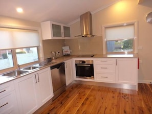 Well appointed kitchen with stone tops/glass splashbacks and S/S appliances