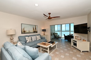 Spacious living room with HDTV, view to Lanai, beach and Gulf of Mexico